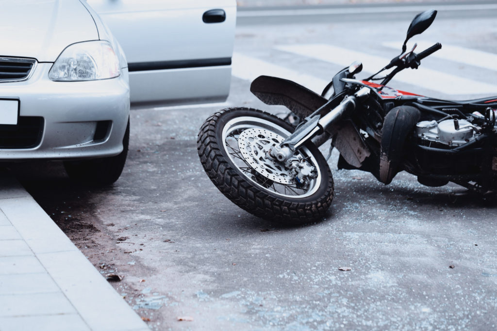 motorcycle on the floor after a crash with a car