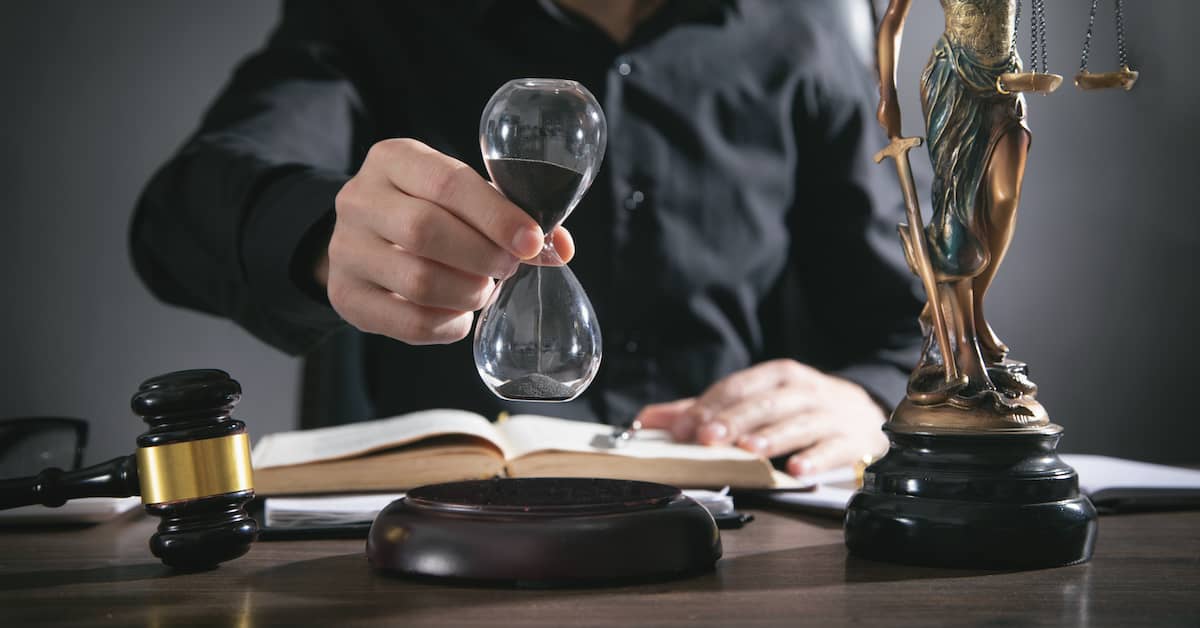 Car accident lawyer holds an hour glass. | Maggiano, DiGirolamo & Lizzi