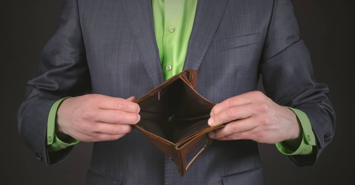 Man in suit holding open an empty wallet. | Maggiano, DiGirolamo & Lizzi