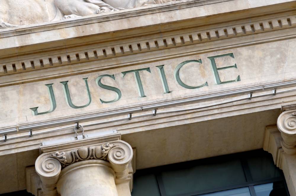 image of court house with word "justice" engraved