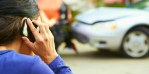 female driver phoning attorney after car accident