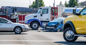 vehicles in the intersection at the scene of a semi-truck accident
