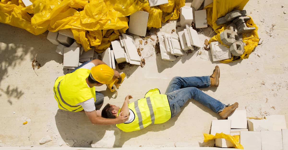 one construction worker helping another after a construction site collapse