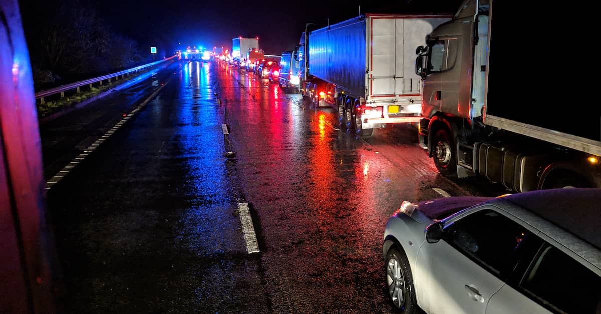 traffic backed up on road at night due to truck accident