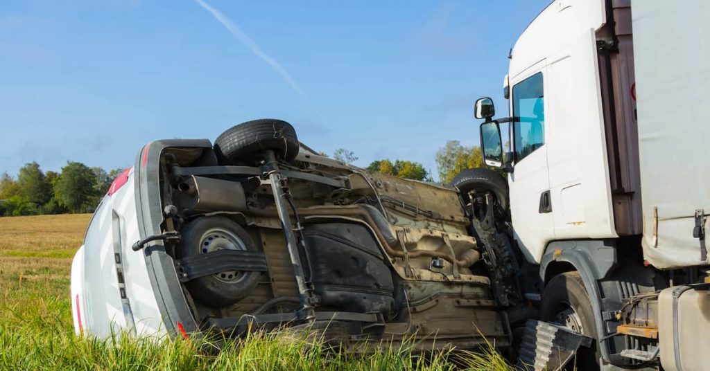 car overturned by a semi-truck in a crash