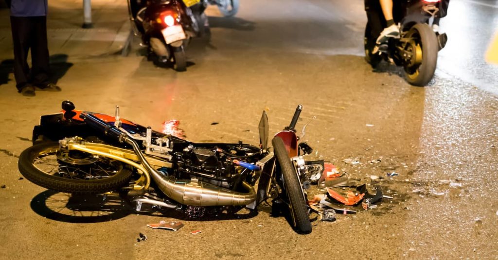 motorcycle accident on road at night