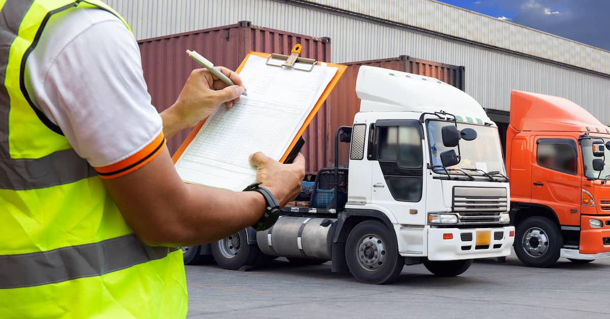 truck driver filling out documents before a haul