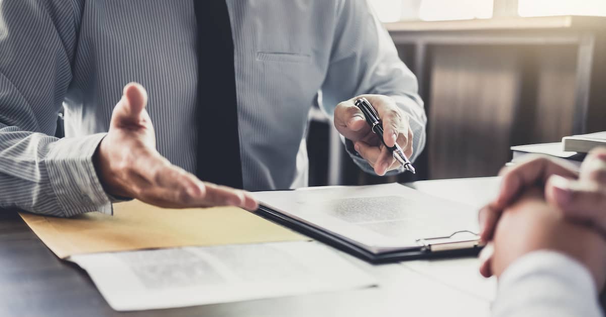 Lawyer discussing personal injury negligence with client at desk. | Maggiano, DiGirolamo & Lizzi