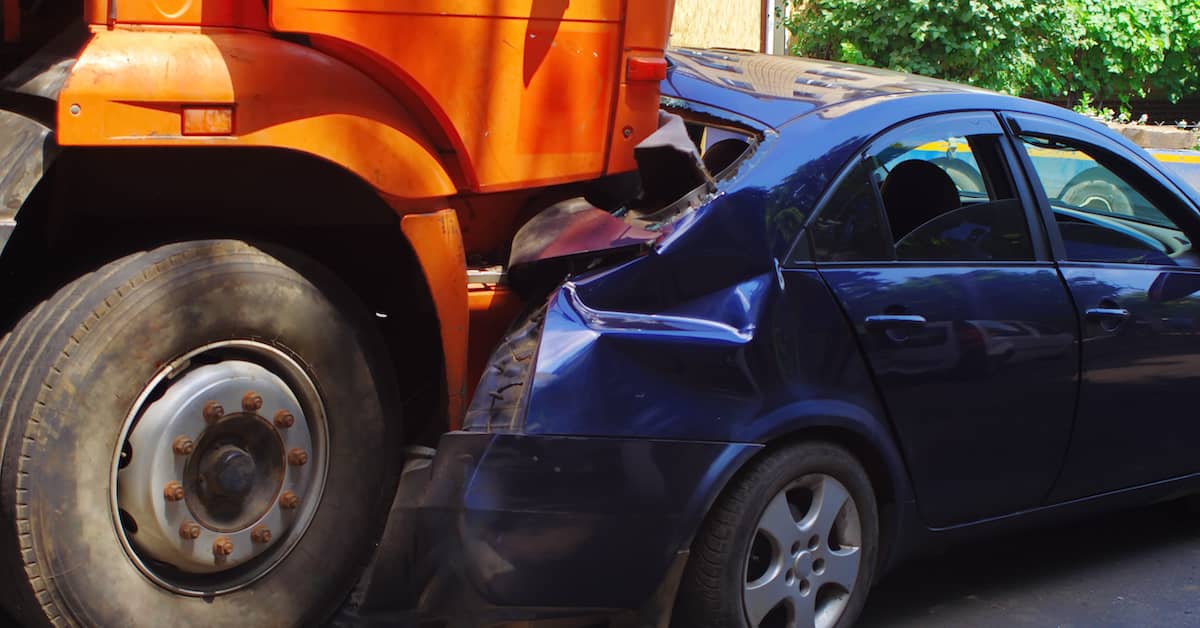 A can and truck locked in a collision. | Maggiano, DiGirolamo & Lizzi