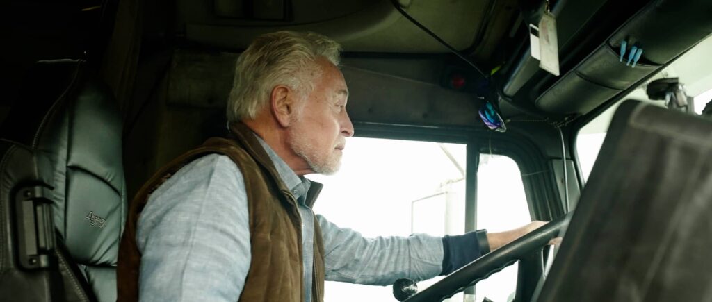 Attorney Michael Maggiano behind the wheel of a big rig truck at the TruckLaw Symposium | Maggiano, DiGirolamo & Lizzi