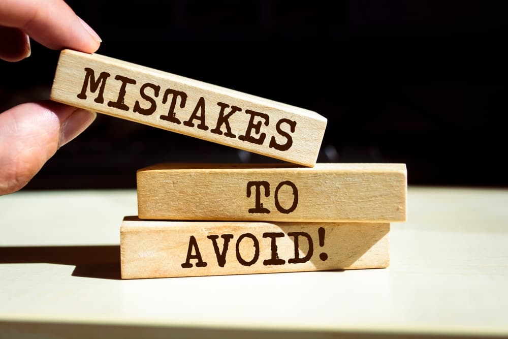 Wooden blocks with words 'Mistakes To Avoid'.
