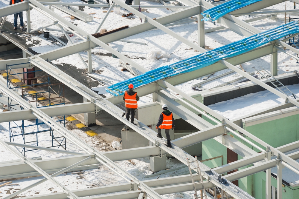 Construction site with workers on the building roof