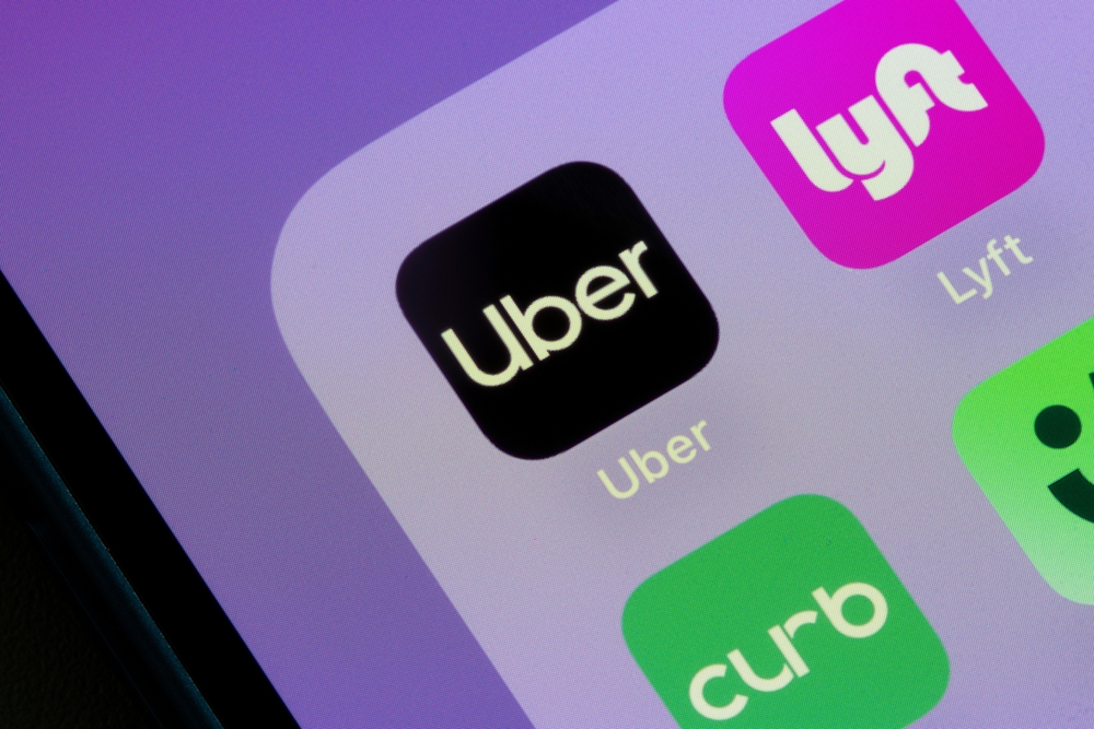 Uber and Lyft rideshare app icons displayed on a smartphone home screen