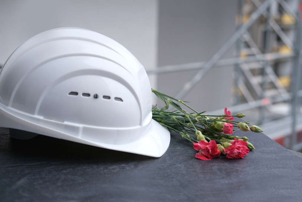 construction hard hat and flowers arranged as a memorial